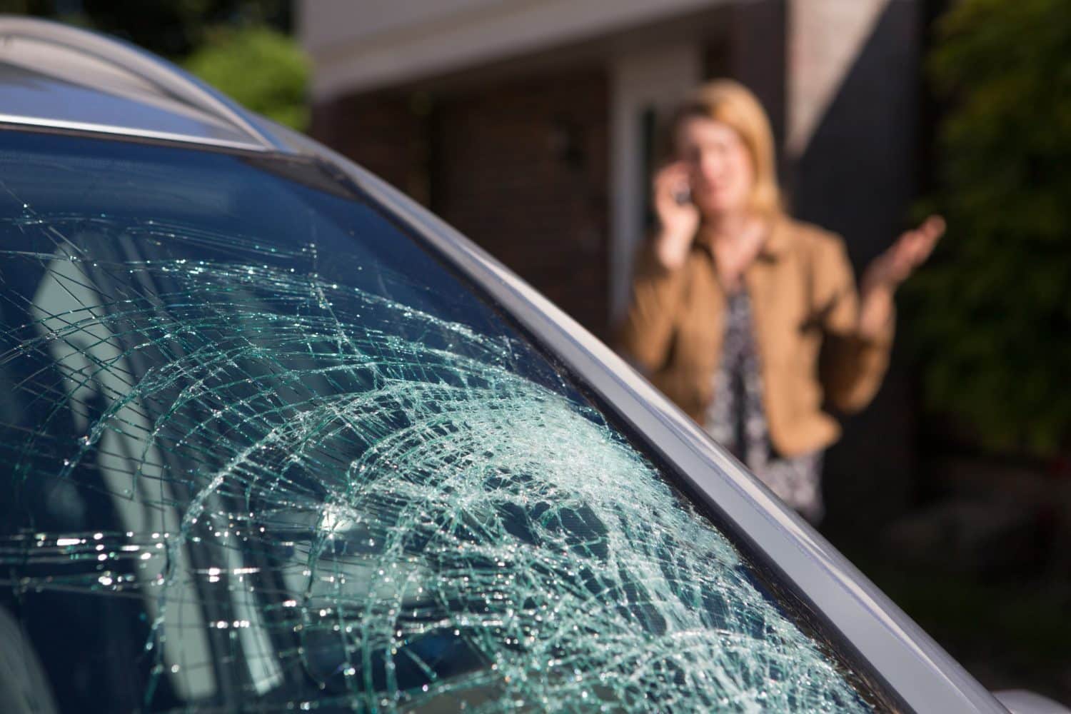 A broken windshield after a car accident.