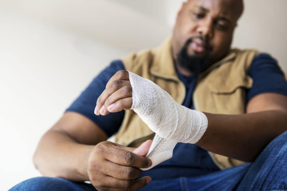 A Cambridge, MA, man wrapping his injured wrist.