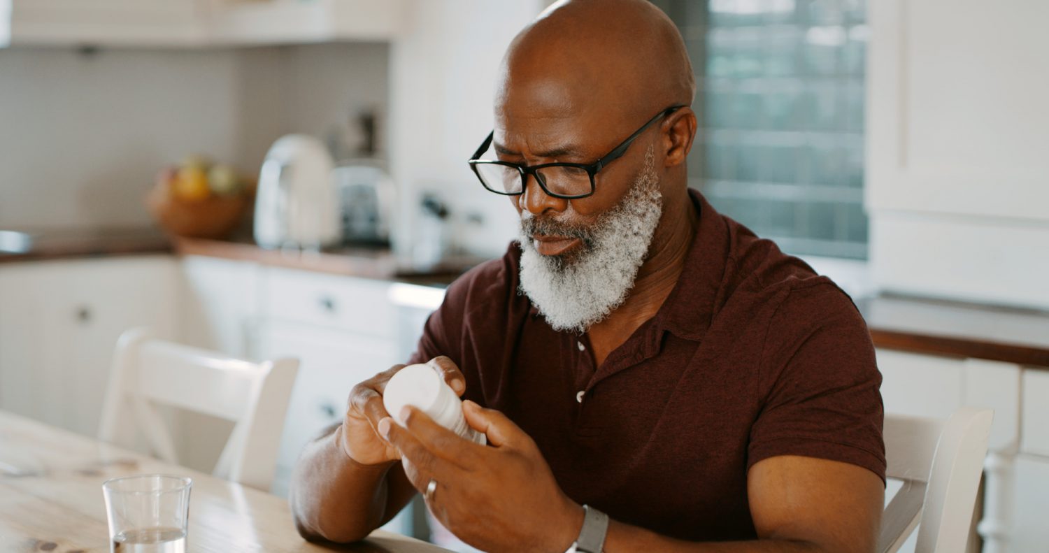 man checking his medication to make sure it’s correct