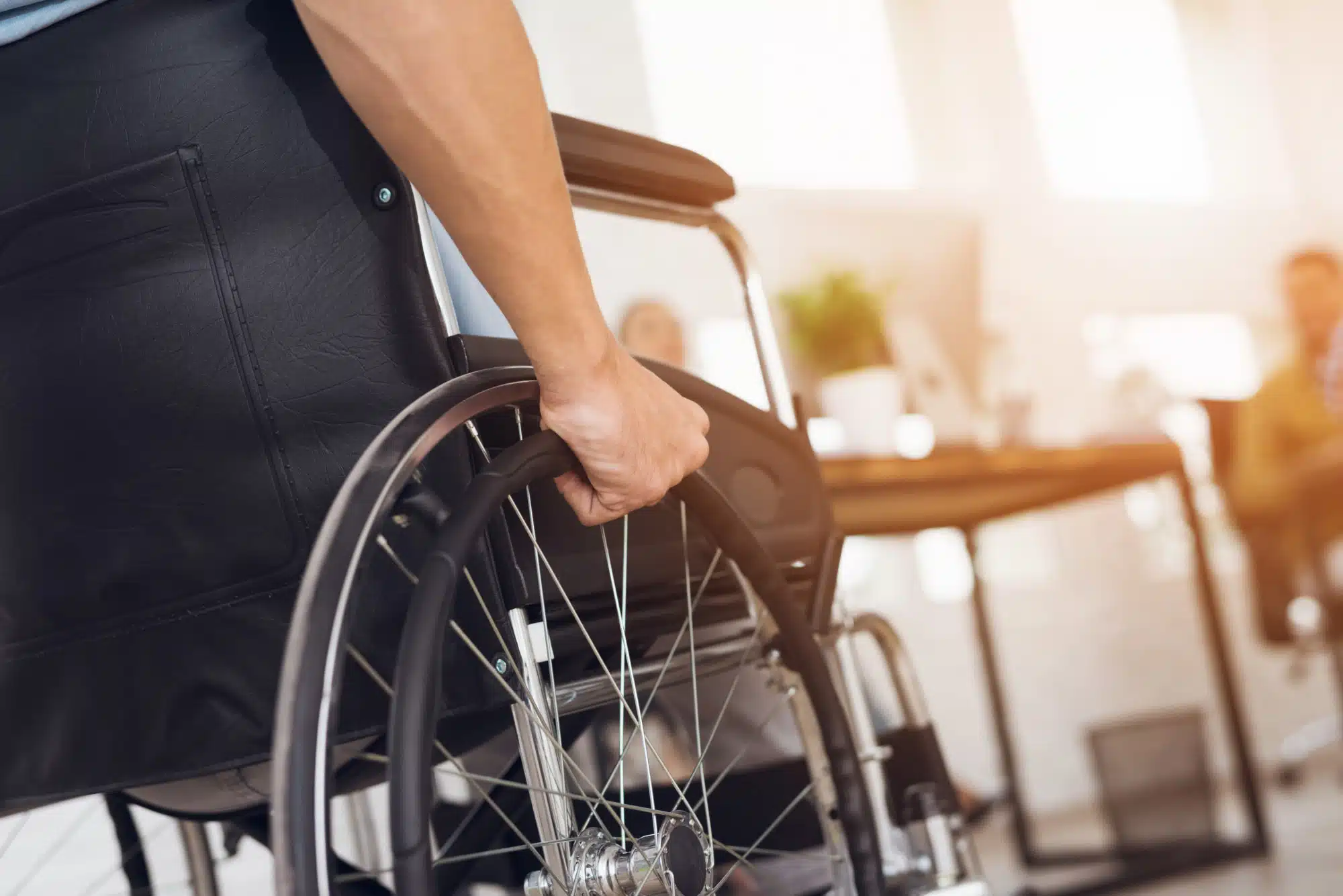 A person in a wheelchair at an appointment in an office.