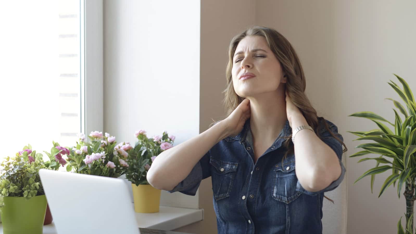 Young Woman With Neck Pain Stock Photo
