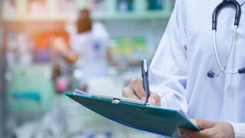 Doctor Writing Prescription Stock Photo