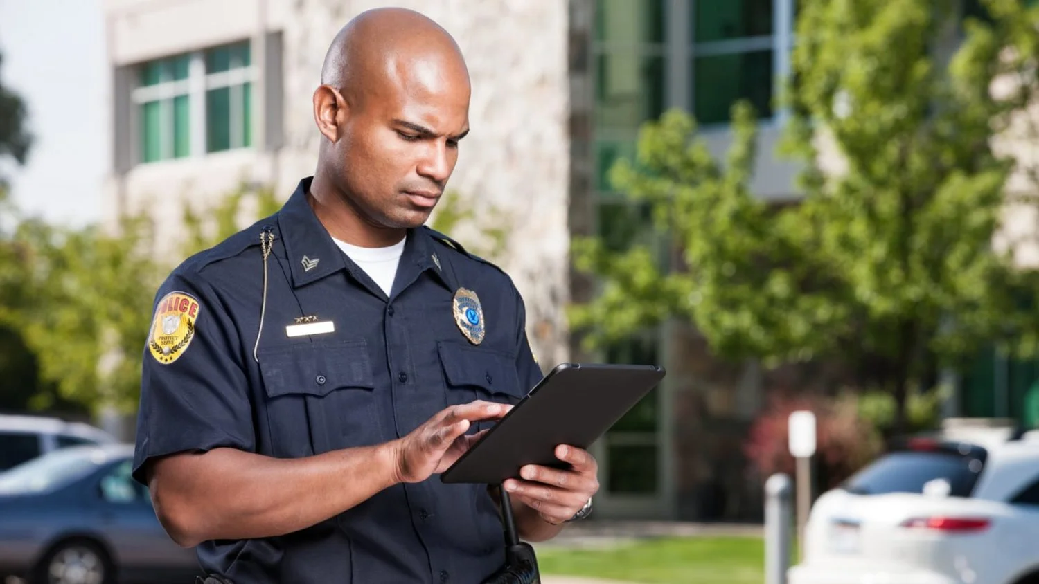 A police officer completes an accident report at the scene of a car accident.