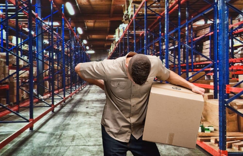 A warehouse employee with an injured back after lifting heavy boxes.