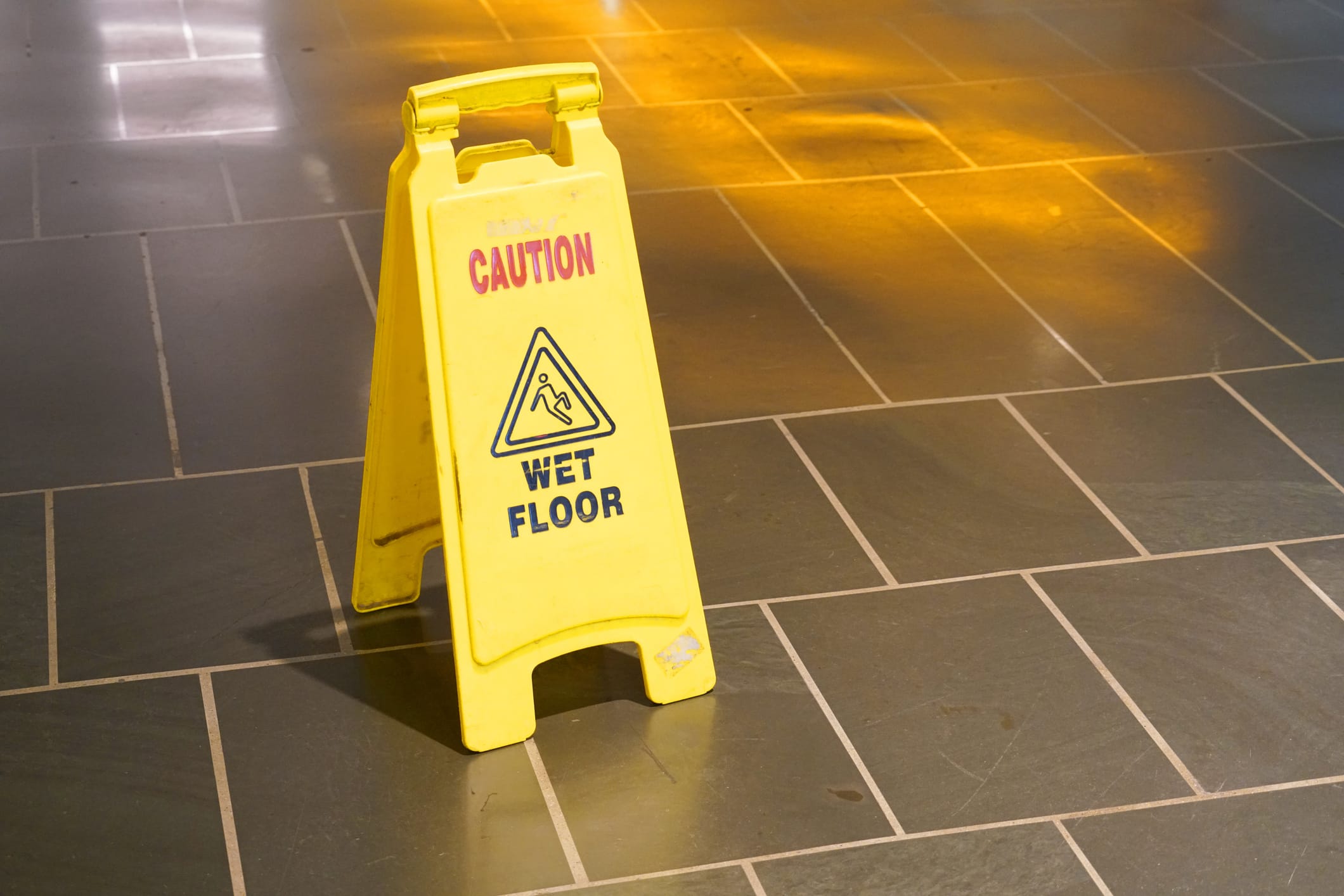 A yellow wet floor sign.
