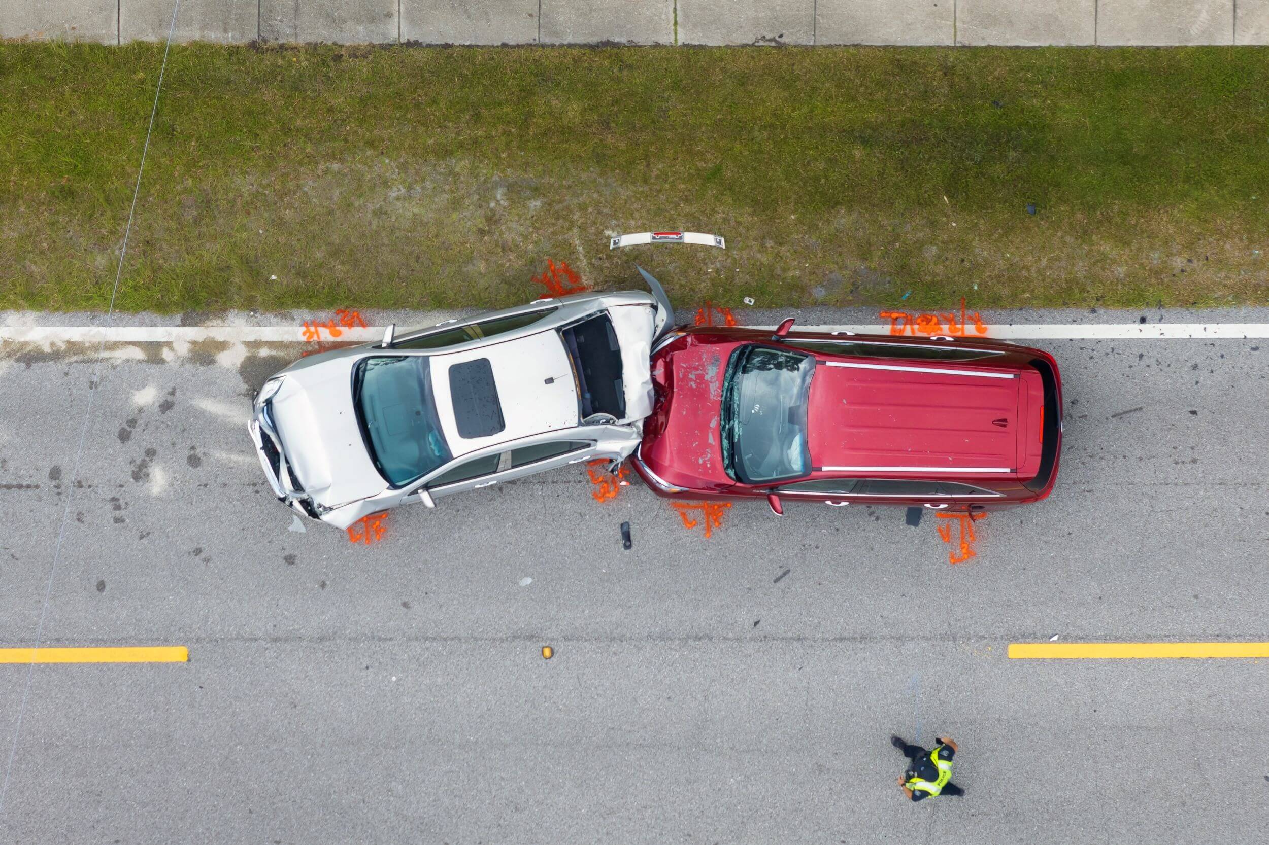 Accident reconstructionist marks pavement with paint after a serious read-end collision.