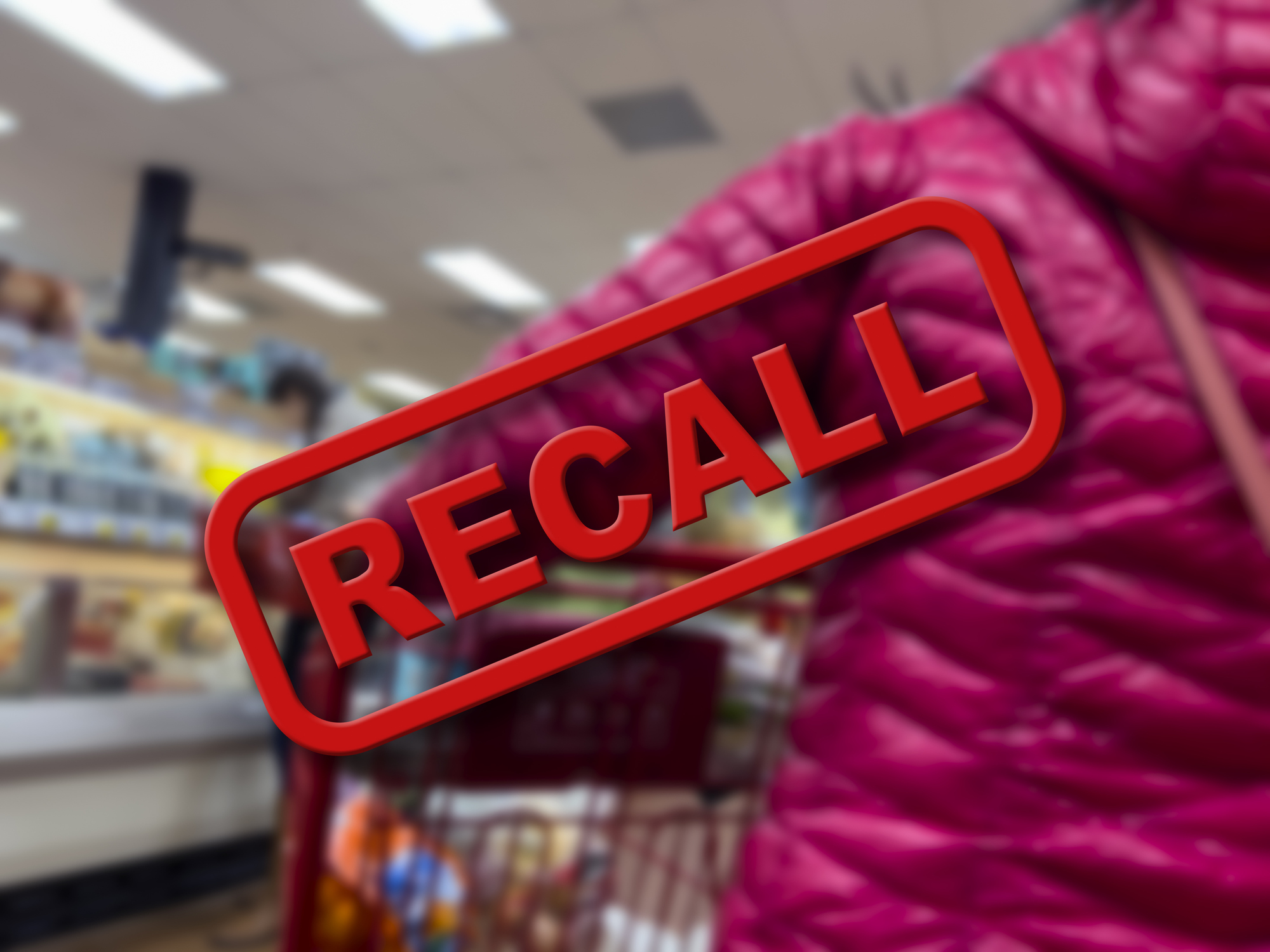 A woman shopping in a supermarket with a “RECALL” label over the picture.
