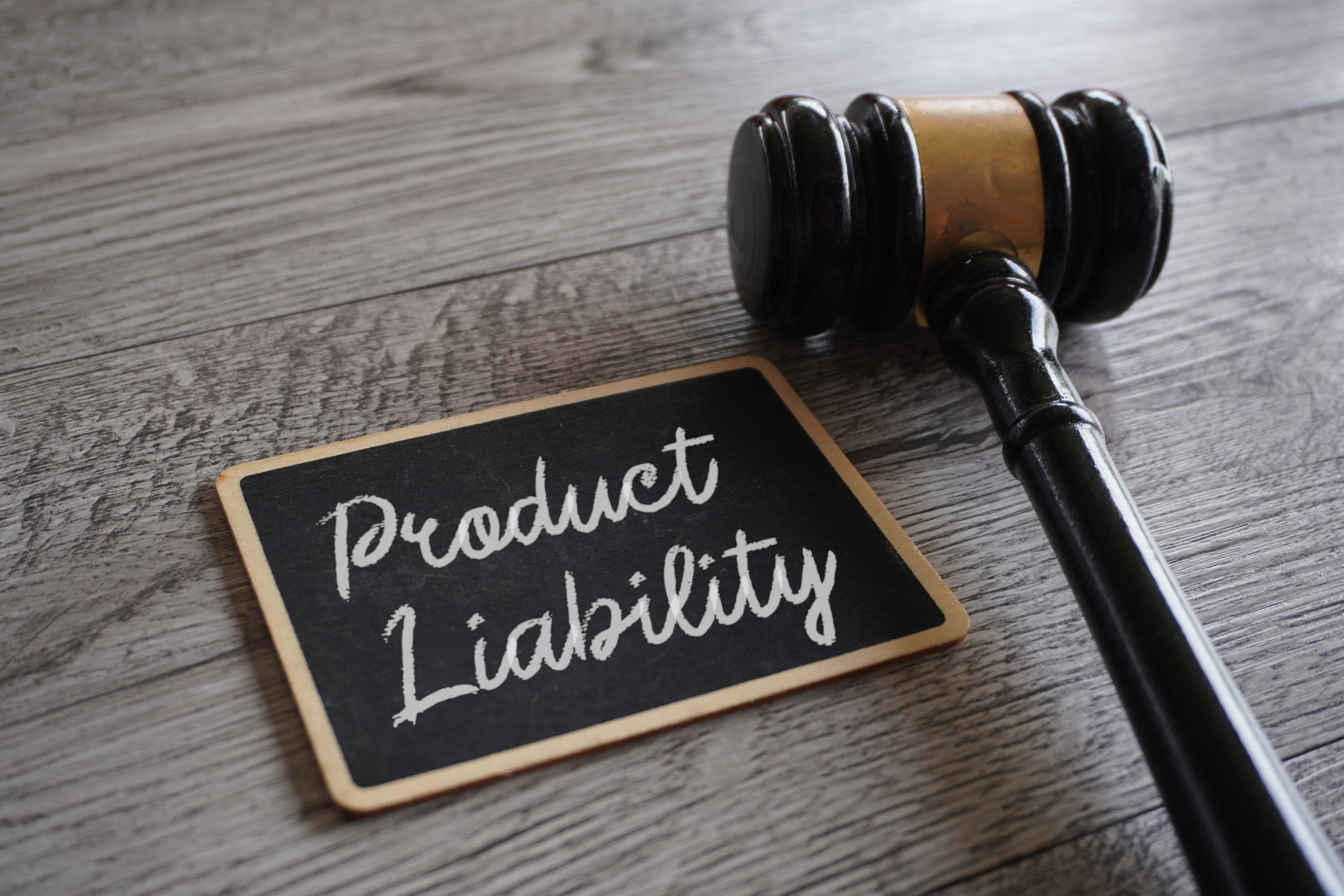 A gavel and a whiteboard with the words “Product Liability”