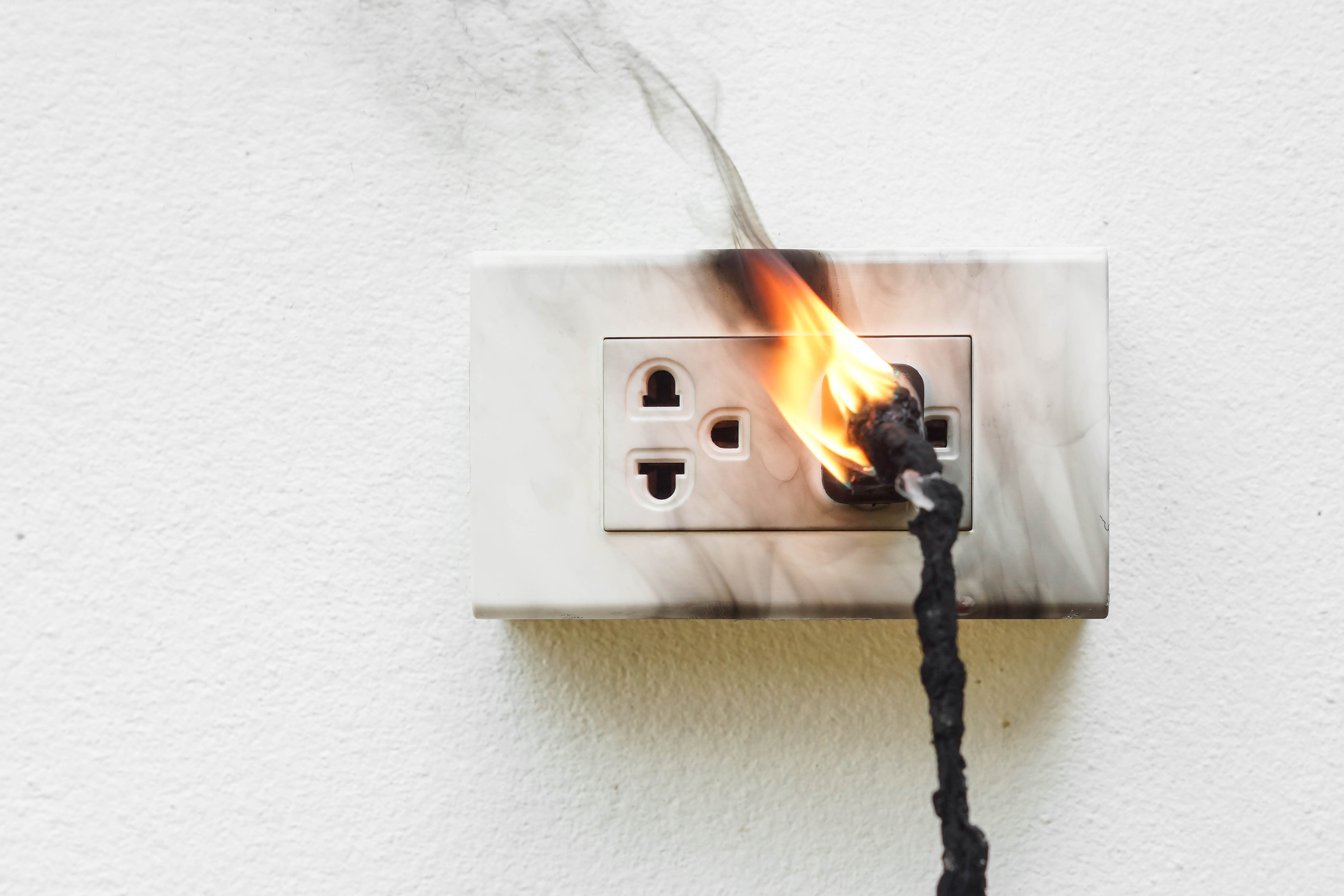 The power cord of a dangerous product has started a fire while plugged into the wall.
